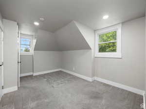 Additional living space with baseboards, carpet flooring, lofted ceiling, and recessed lighting