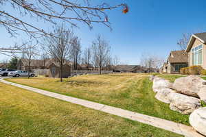 View of yard with a residential view and fence