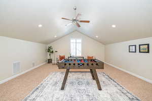 Playroom featuring baseboards, visible vents, lofted ceiling, and ceiling fan