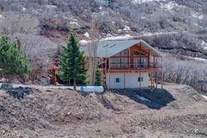 Back of property with a wooden deck