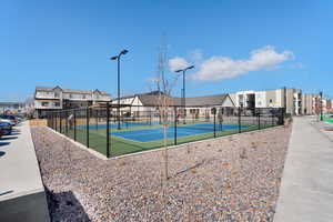 View of sport court featuring a residential view and fence