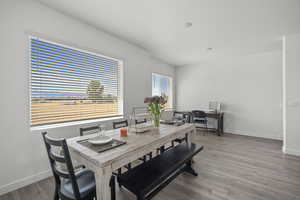 Dining space featuring baseboards and light wood-type flooring