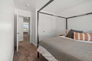 Carpeted bedroom featuring baseboards and visible vents