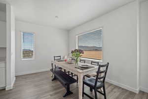 Dining room with baseboards and light wood finished floors