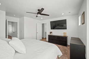 Bedroom with visible vents, ceiling fan, and carpet