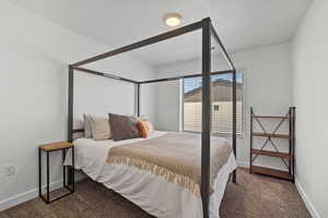 Carpeted bedroom with baseboards