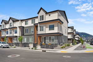 View of property with a mountain view and a residential view