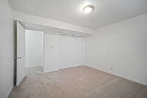 Unfurnished bedroom with baseboards, a closet, and carpet