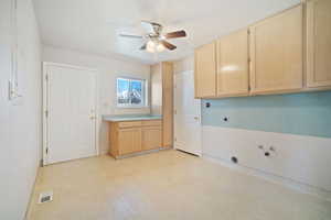 Clothes washing area with electric dryer hookup, cabinet space, visible vents, ceiling fan, and hookup for a washing machine