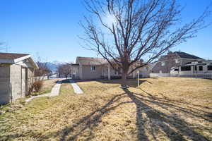 View of yard with fence and a mountain view