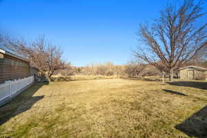 View of yard featuring fence