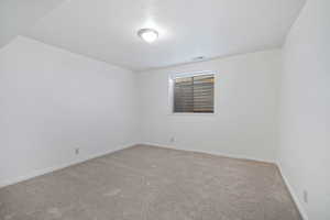 Unfurnished room with light colored carpet, visible vents, and baseboards