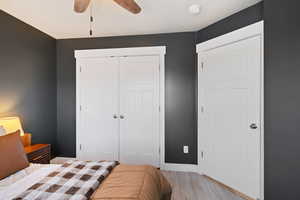 Bedroom featuring a closet, baseboards, ceiling fan, and light wood-style flooring