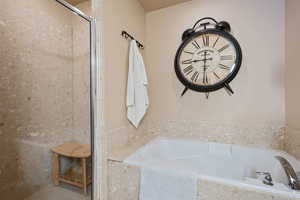 Bathroom featuring a garden tub and walk in shower