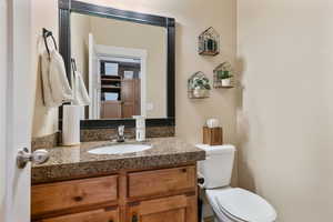 Half bathroom featuring toilet and vanity