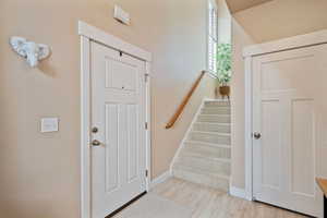 Staircase featuring baseboards and wood finished floors