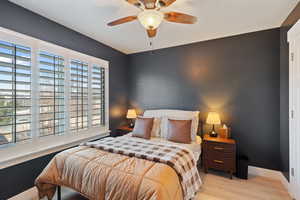 Bedroom with baseboards, ceiling fan, and wood finished floors