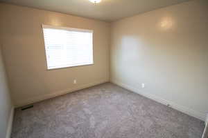 Spare room featuring carpet flooring
