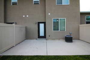Rear view of property with a patio and stucco siding
