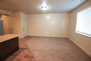 Unfurnished living room with baseboards and dark wood finished floors