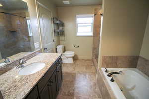 Full bathroom with a garden tub, vanity, and a tile shower
