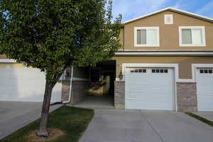 View of front of home featuring stucco siding and driveway