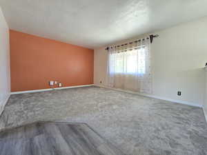 Unfurnished room with carpet flooring and baseboards