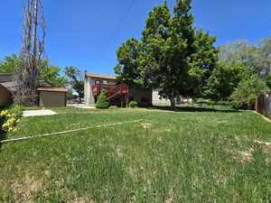 View of yard featuring stairs and a deck