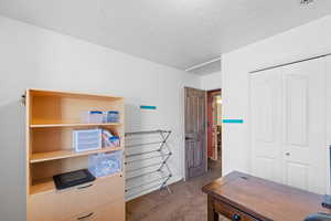 Bedroom/Carpeted home office featuring a textured ceiling