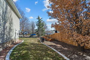 View of yard featuring fence