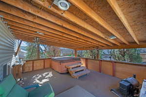 View of patio featuring area for grilling and a hot tub