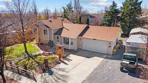 View of front of home featuring brick siding, concrete driveway, a shingled roof, and an attached garage