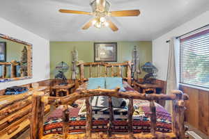 Master Bedroom with wainscoting, a ceiling fan, a textured ceiling, and visible vents