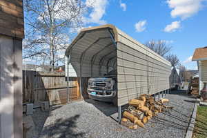 View of outdoor structure with gravel driveway, a carport, and fence/Not included but negotiable