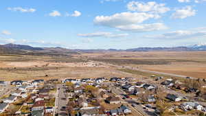 Birds eye view of property featuring a mountain view and a residential view