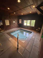 View of pool with a swimming pool and a hot tub