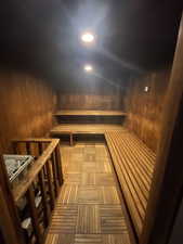 Relaxing sauna with wood walls and recessed lighting