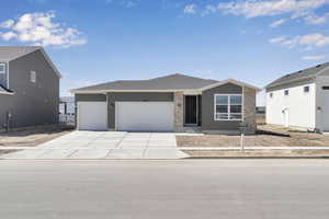 Single story home with a garage and concrete driveway