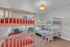 Carpeted bedroom featuring baseboards