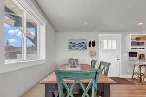 Dining room with a wealth of natural light, visible vents, recessed lighting, and light wood finished floors