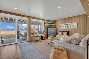Living room with wood walls, recessed lighting, a mountain view, visible vents, and wood finished floors