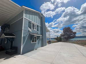 View of side of home featuring a water view and board and batten siding