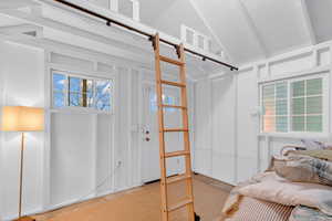 Unfurnished bedroom featuring lofted ceiling