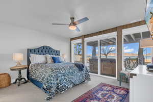 Carpeted bedroom featuring visible vents, ceiling fan, access to outside, and multiple windows