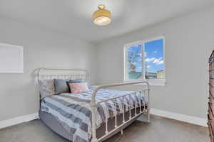 Carpeted bedroom with baseboards