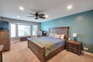 Bedroom with light colored carpet, recessed lighting, baseboards, and a ceiling fan