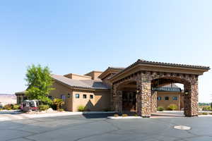 Mediterranean / spanish-style home with stone siding, stucco siding, and a tile roof