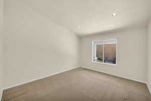 Spare room featuring carpet, recessed lighting, and a textured ceiling