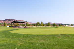View of property's community featuring a mountain view, a putting green, and golf course view