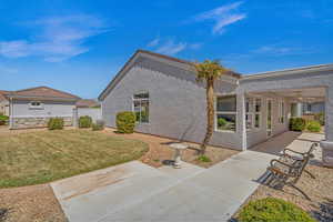 Back of house featuring a patio area, stucco siding, and ceiling fan